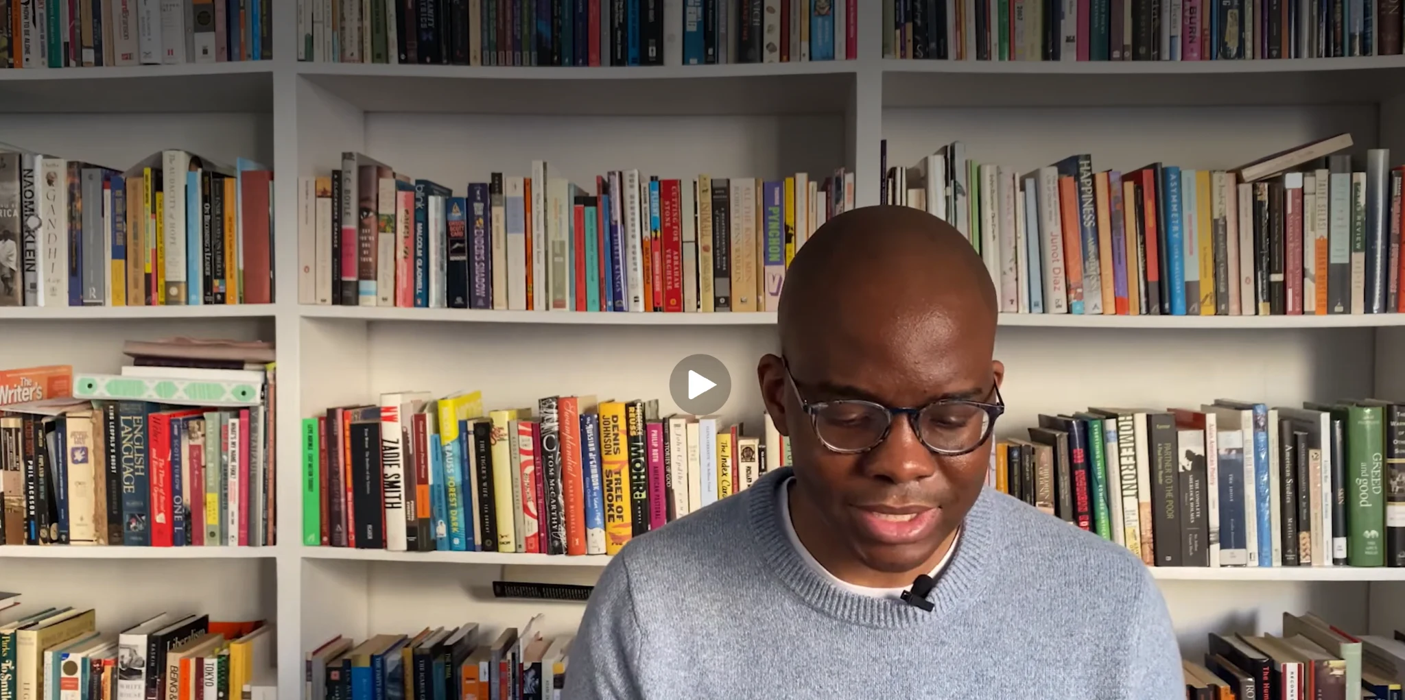 Tope Folarin reading in front of bookshelves during his 2021 Whiting Award reading.